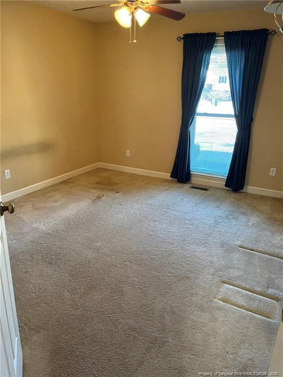 empty room featuring ceiling fan and carpet floors