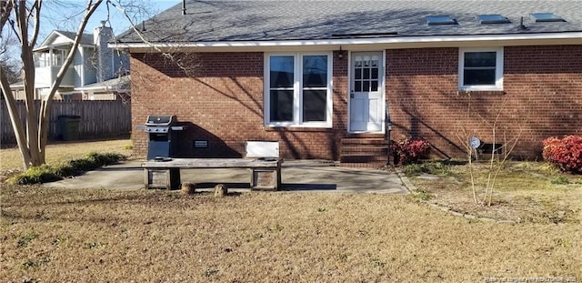 back of house with a patio and a yard