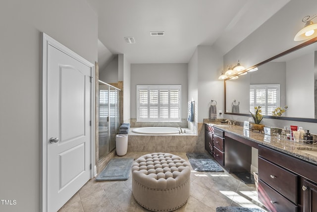 bathroom featuring vanity, tile patterned flooring, and plus walk in shower