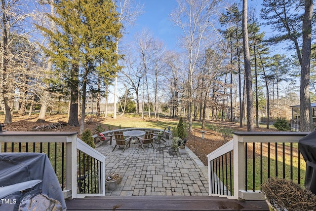 wooden deck with a patio and area for grilling