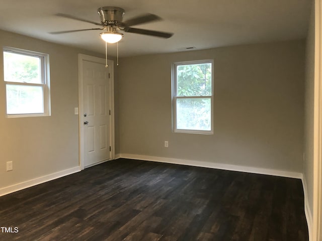 empty room featuring ceiling fan and dark wood-type flooring