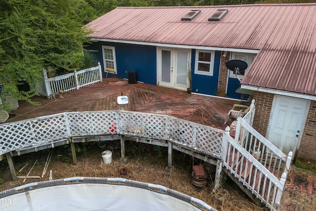 exterior space featuring french doors, cooling unit, and a wooden deck