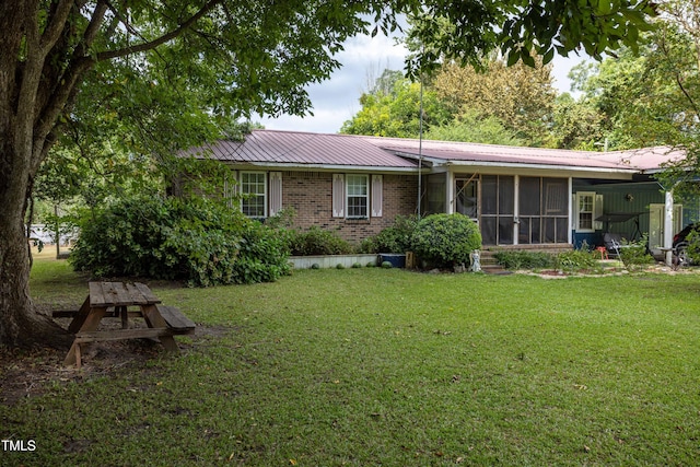 exterior space with a sunroom and a yard