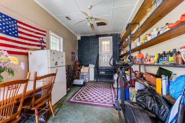 kitchen with white fridge, dark carpet, ceiling fan, and crown molding