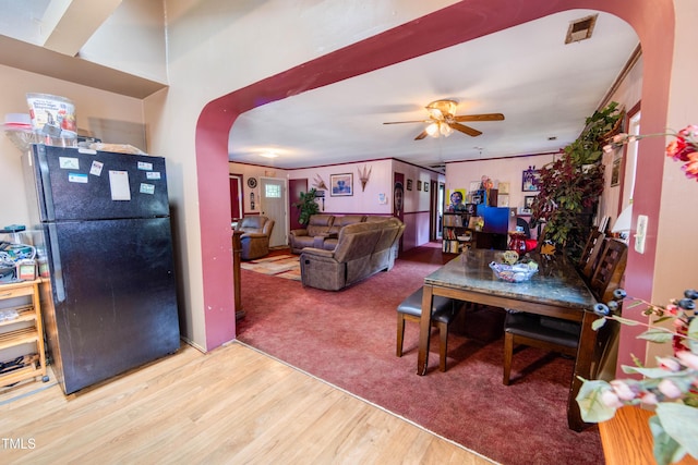 living room featuring ceiling fan, wood-type flooring, and ornamental molding