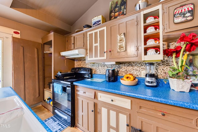 kitchen featuring electric range, lofted ceiling, backsplash, and light brown cabinetry