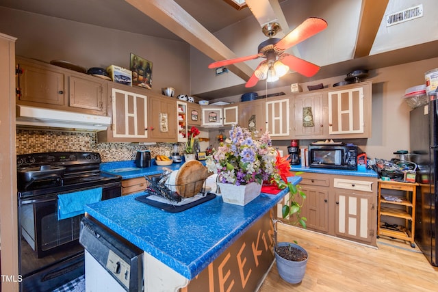 kitchen with light brown cabinetry, tasteful backsplash, black appliances, a center island, and light hardwood / wood-style floors