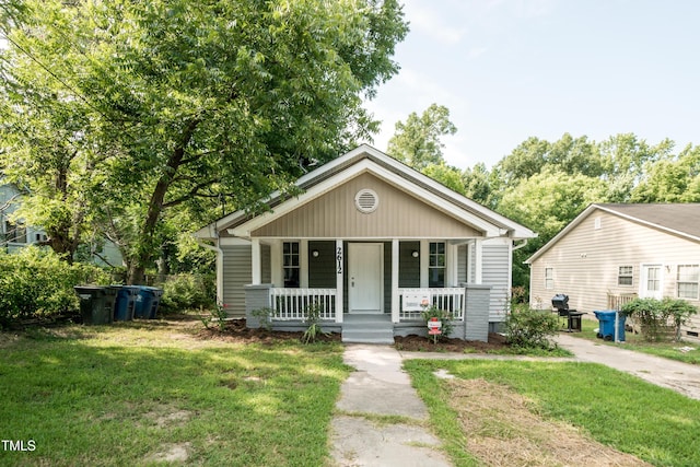 bungalow featuring a front lawn and a porch