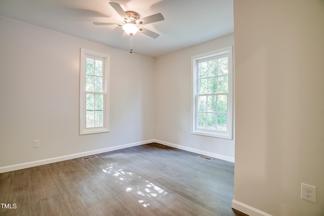 empty room featuring hardwood / wood-style floors and ceiling fan