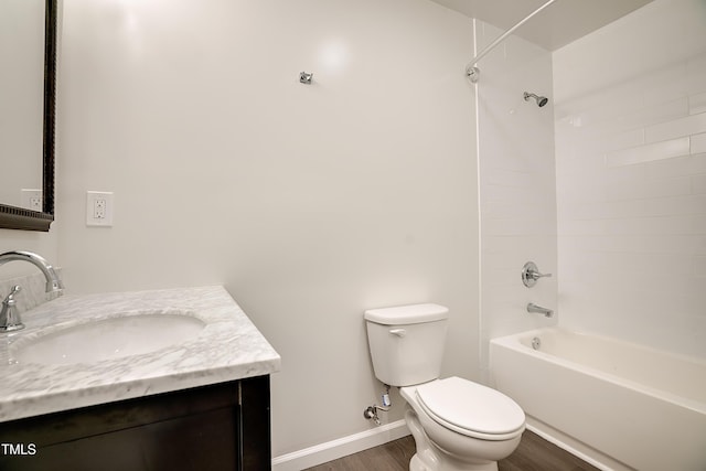 full bathroom with hardwood / wood-style floors, vanity, shower / bath combination, and toilet