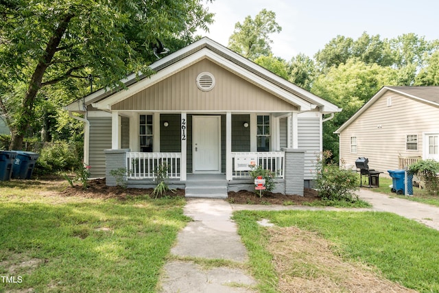 bungalow-style home with a front lawn