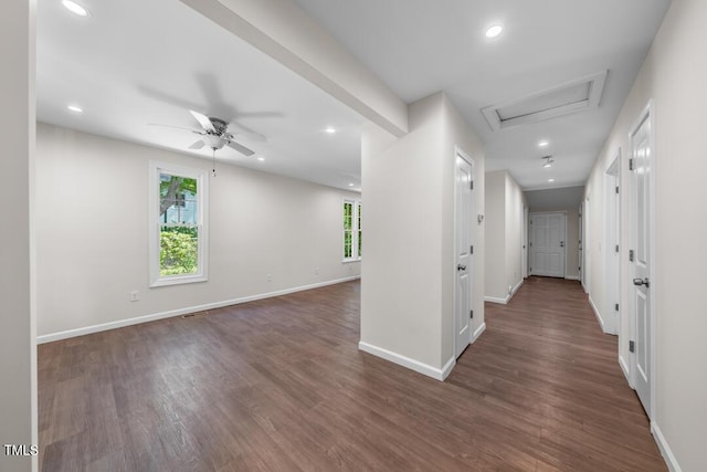 corridor with plenty of natural light, baseboards, wood finished floors, and recessed lighting