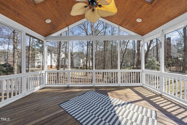 unfurnished sunroom with ceiling fan, wood ceiling, and vaulted ceiling