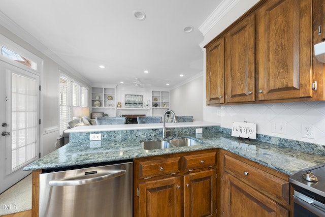 kitchen with light stone counters, a peninsula, stainless steel appliances, crown molding, and a sink