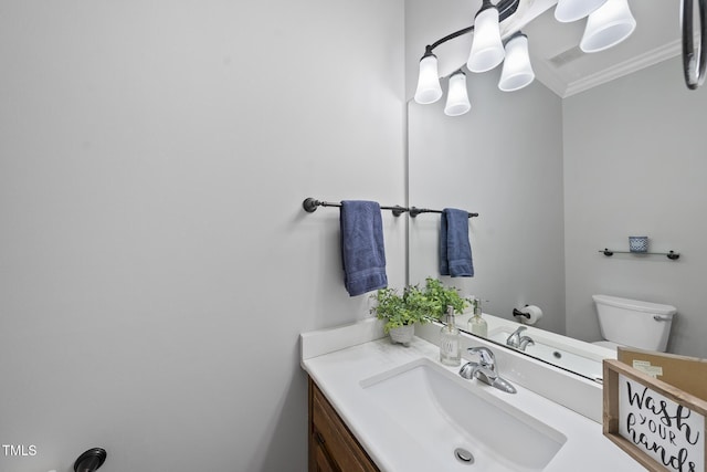 bathroom with toilet, visible vents, ornamental molding, and vanity