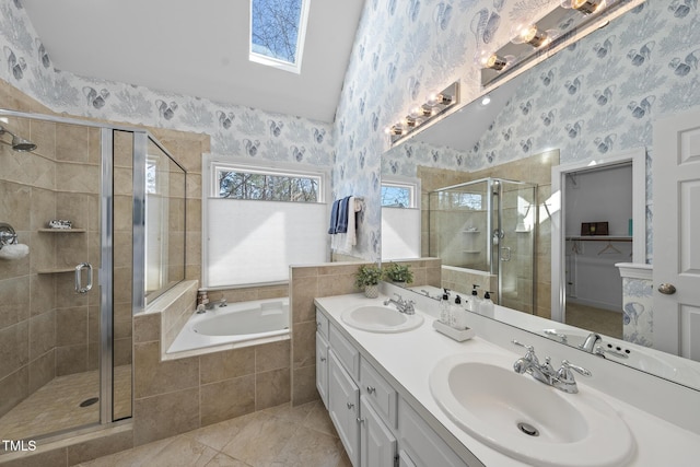 full bathroom featuring wallpapered walls, a garden tub, and a sink