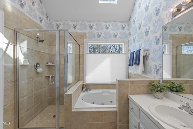 full bathroom with a stall shower, vanity, a whirlpool tub, and wallpapered walls