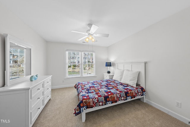 bedroom with baseboards, ceiling fan, and light colored carpet