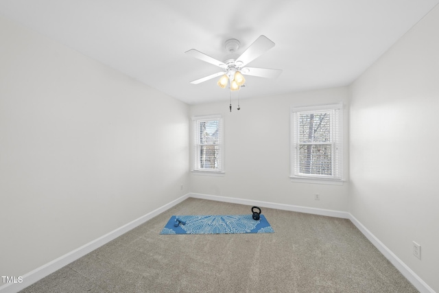 workout room with carpet, baseboards, and ceiling fan