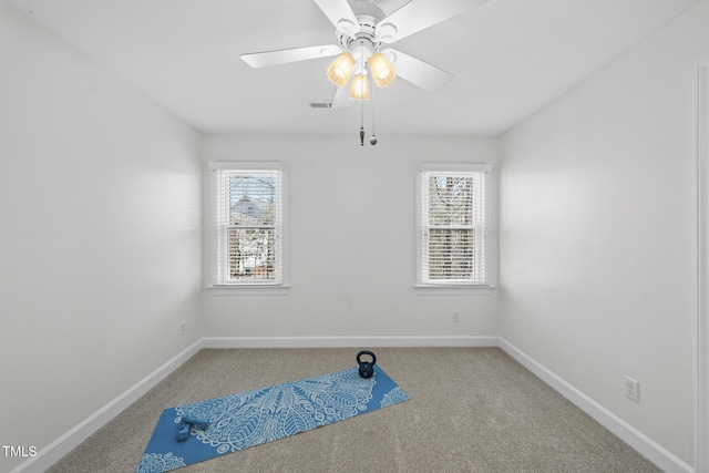 interior space featuring plenty of natural light, visible vents, ceiling fan, and baseboards