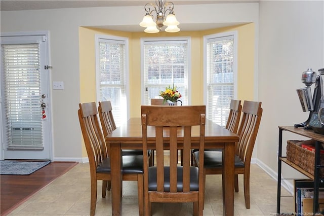 tiled dining area featuring an inviting chandelier