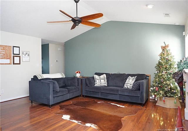 living room featuring ceiling fan, dark hardwood / wood-style flooring, and vaulted ceiling