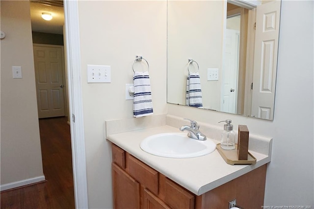 bathroom with hardwood / wood-style flooring and vanity