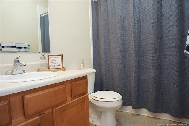 bathroom with tile patterned floors, vanity, and toilet