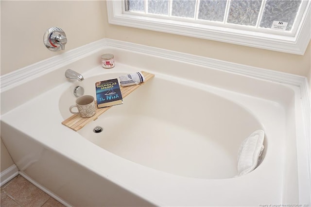 bathroom featuring tile patterned floors and a tub