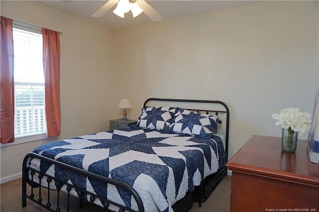 bedroom with carpet flooring, multiple windows, and ceiling fan