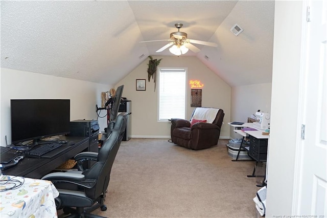 carpeted office space with a textured ceiling, vaulted ceiling, and ceiling fan