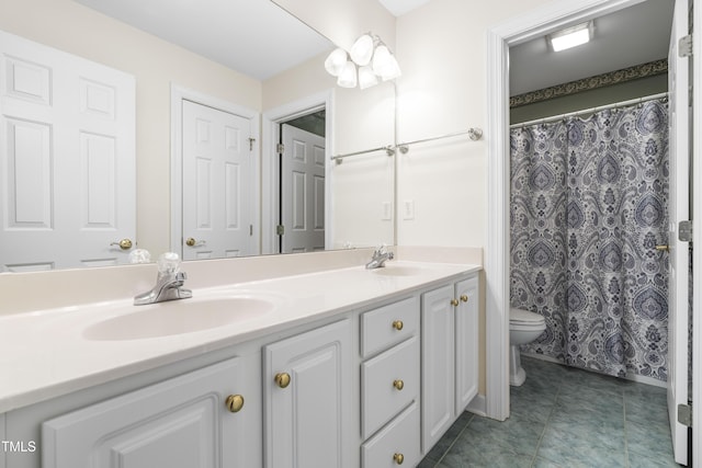 bathroom featuring toilet and vanity