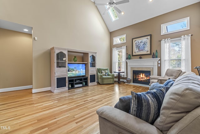 living room featuring ceiling fan, a high ceiling, and hardwood / wood-style floors