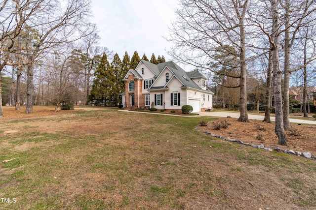 view of front of house with a front yard and a garage