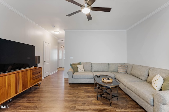 living room with ceiling fan, dark hardwood / wood-style flooring, and crown molding