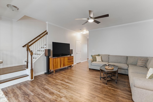 living room with ceiling fan, wood-type flooring, and ornamental molding