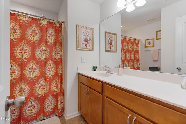 bathroom featuring a shower with shower curtain, tile patterned floors, and vanity