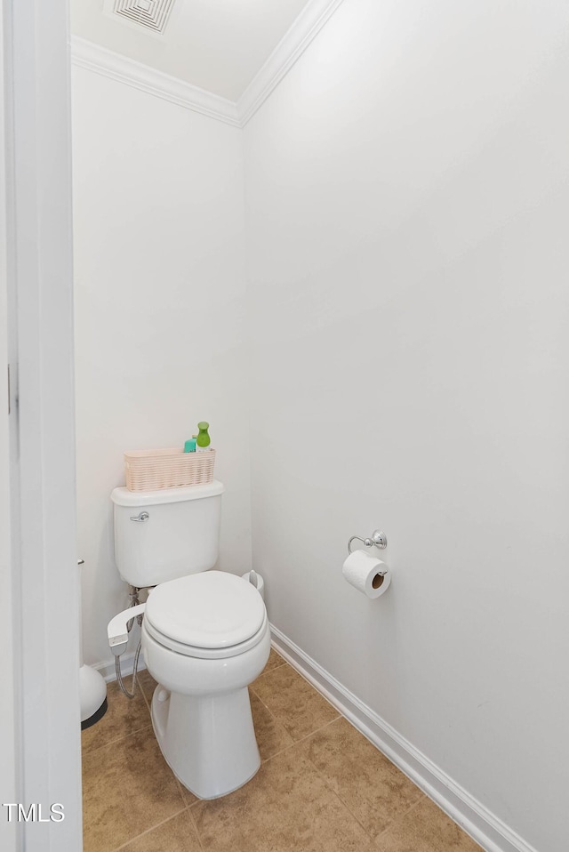 bathroom with toilet and crown molding