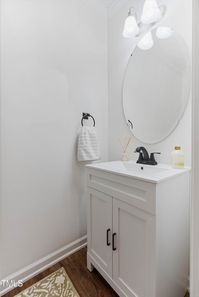 bathroom with hardwood / wood-style floors, vanity, and crown molding