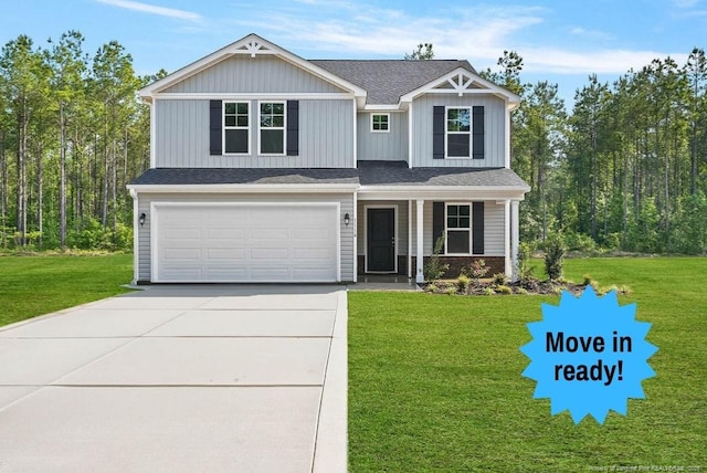 1114 Talmage Rd, Saint Pauls, NC 28384 - view of front of home featuring driveway, an attached garage, a front lawn, and covered porch