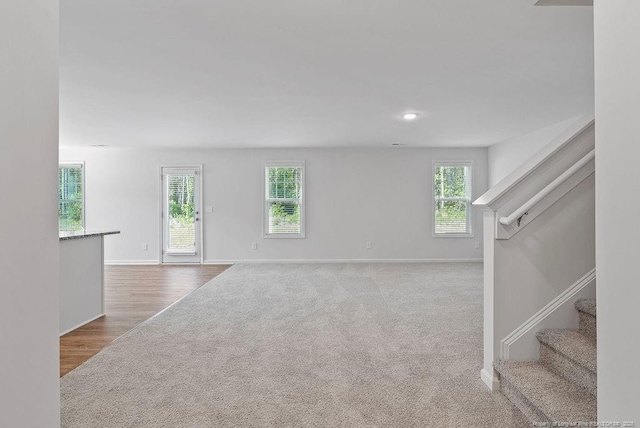 1114 Talmage Rd, Saint Pauls, NC 28384 - unfurnished living room featuring baseboards, stairway, and carpet