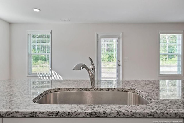 1114 Talmage Rd, Saint Pauls, NC 28384 - kitchen view of a sink, light stone counters, and recessed lighting