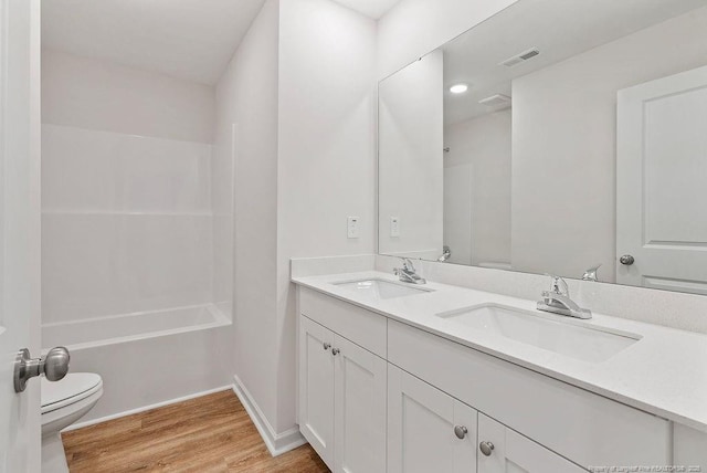 1114 Talmage Rd, Saint Pauls, NC 28384 - full bathroom featuring toilet, wood finished floors, double vanity, bathtub / shower combination, and baseboards