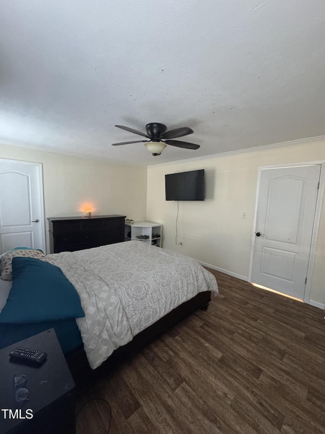 bedroom with ceiling fan and dark wood-type flooring