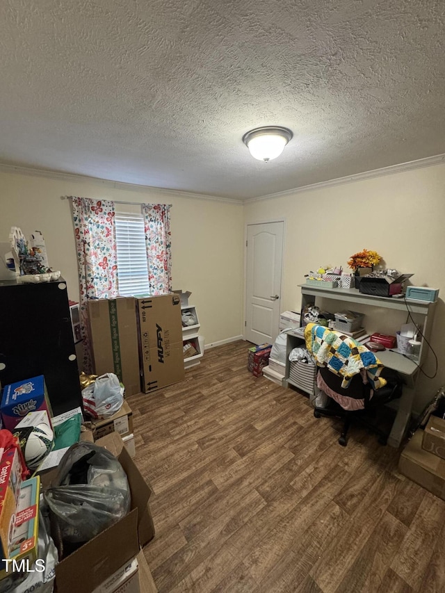 miscellaneous room with wood-type flooring, ornamental molding, and a textured ceiling