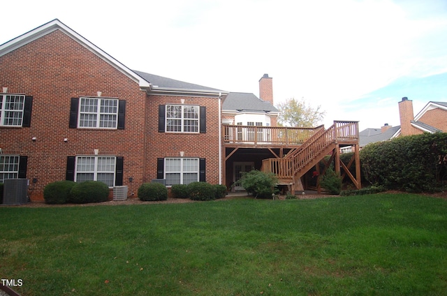 back of house with a lawn, central air condition unit, and a wooden deck