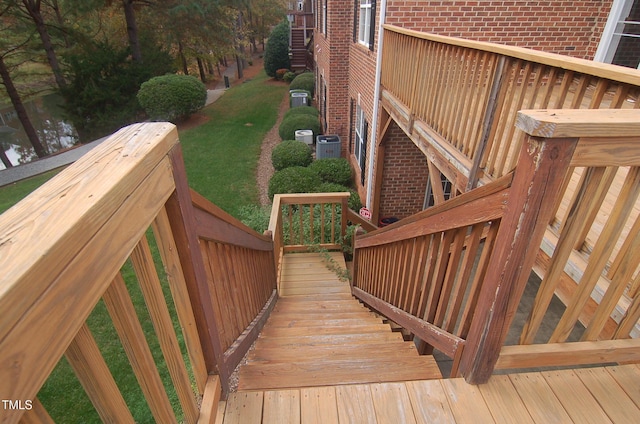 wooden deck featuring a yard and central air condition unit