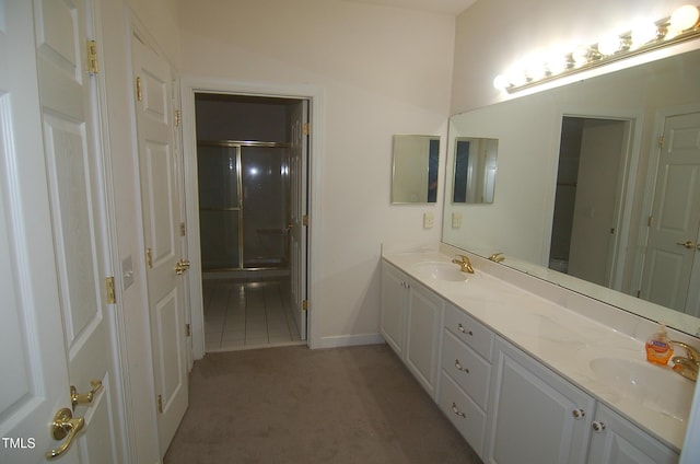 bathroom featuring walk in shower and vanity