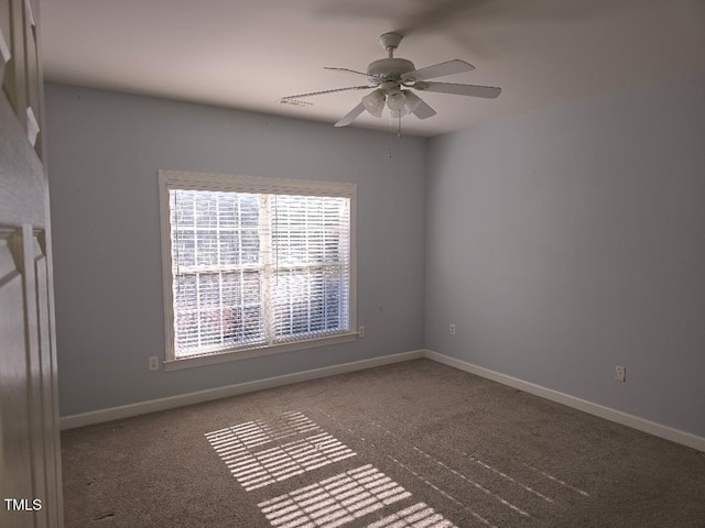 spare room featuring ceiling fan and carpet