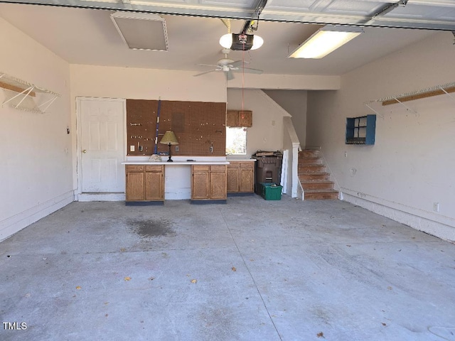 garage with a garage door opener and ceiling fan